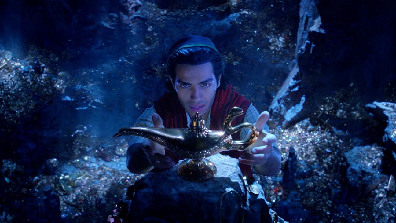 Aladdin reaching for the lamp in the cave of wonders