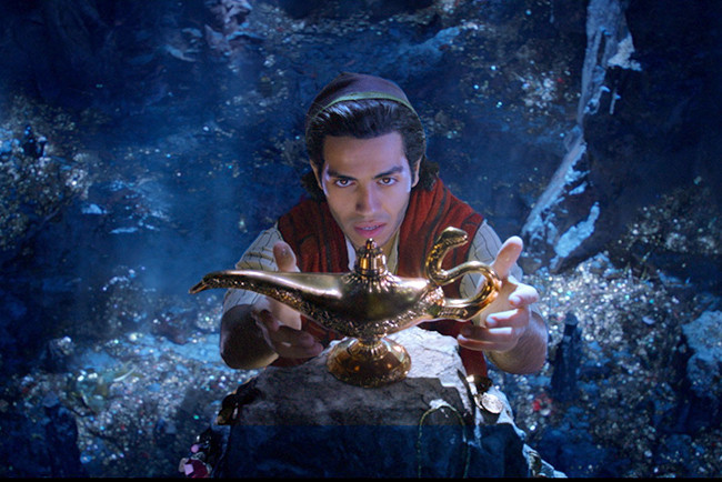 Still from the movie Aladdin showing Alladdin reaching for the lamp in the cave of wonders.