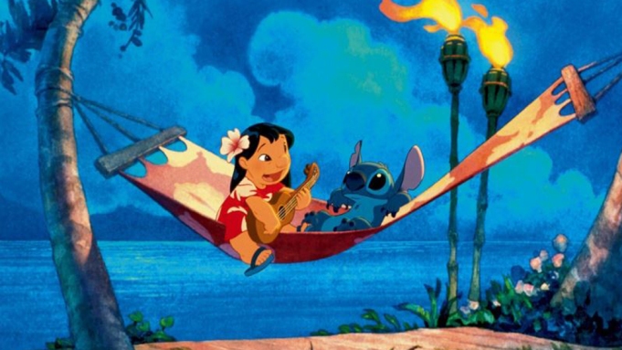 A scene from 'Lilo & Stitch,' released 2002 by Disney showing Lilo and Stich playing music in a hammock.